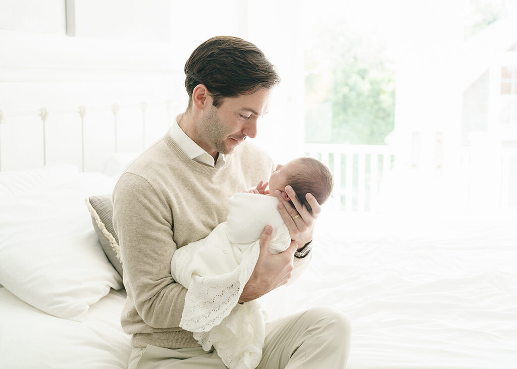 dad photographed in a lifestyle session with his new baby boy