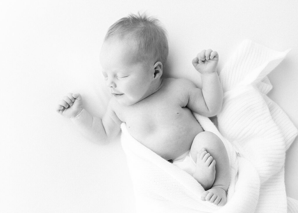 black and white picture of a baby boy photographed lifestyle in studio