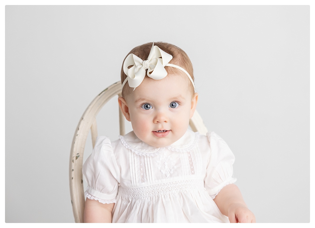 sitting baby photographed in studio wearing a grandmillenial style feltman brothers outfit