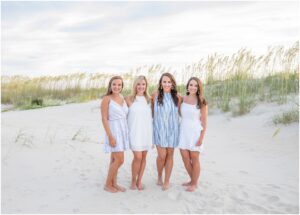 four adult sisters photographed together on a beach on sea island