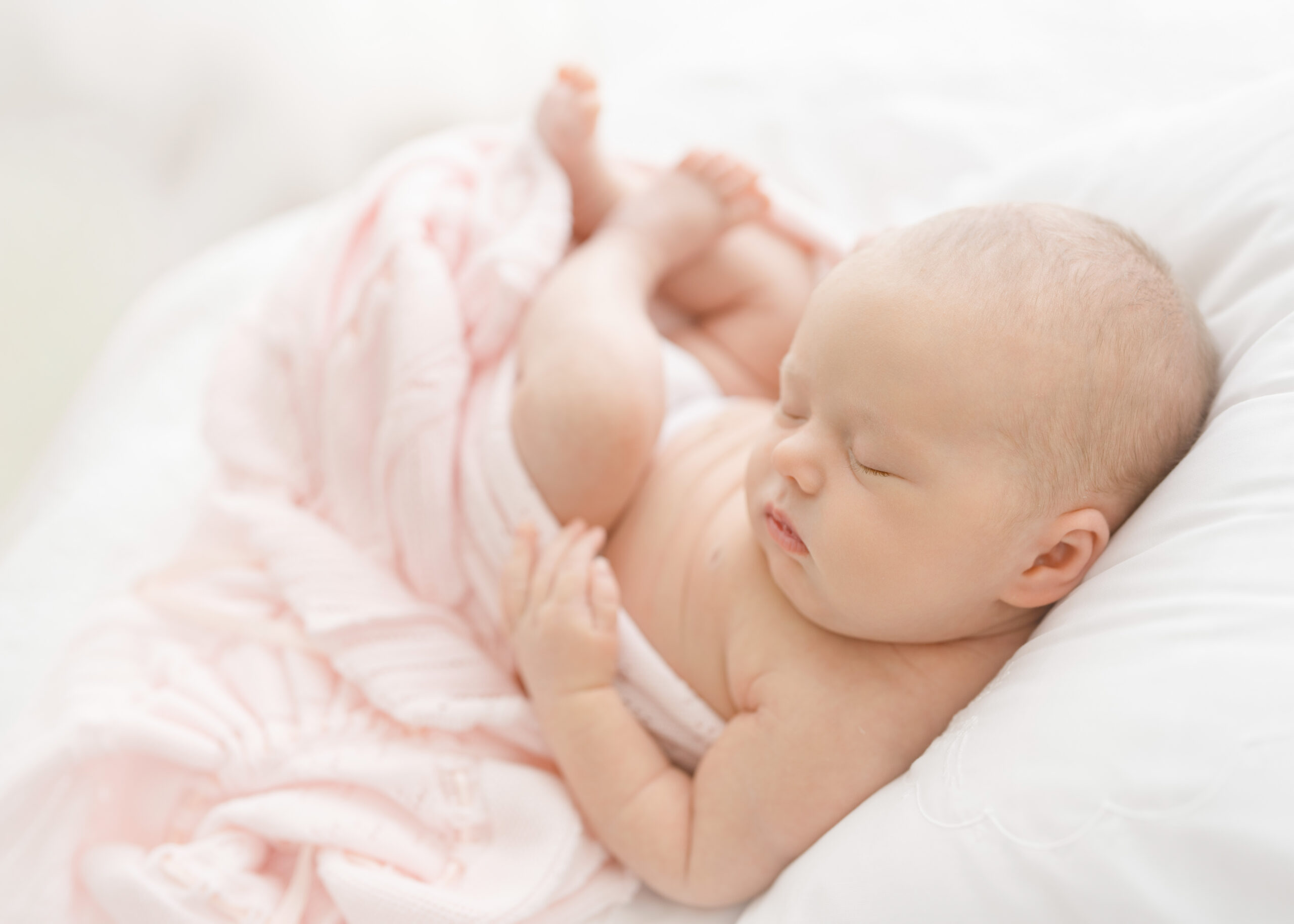 newborn baby girl photographed in a pink feltman brothers blanket grandmilenial style  in a brunswick ga newborn studio